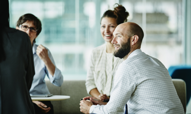 Businessman In Discussion With Colleagues